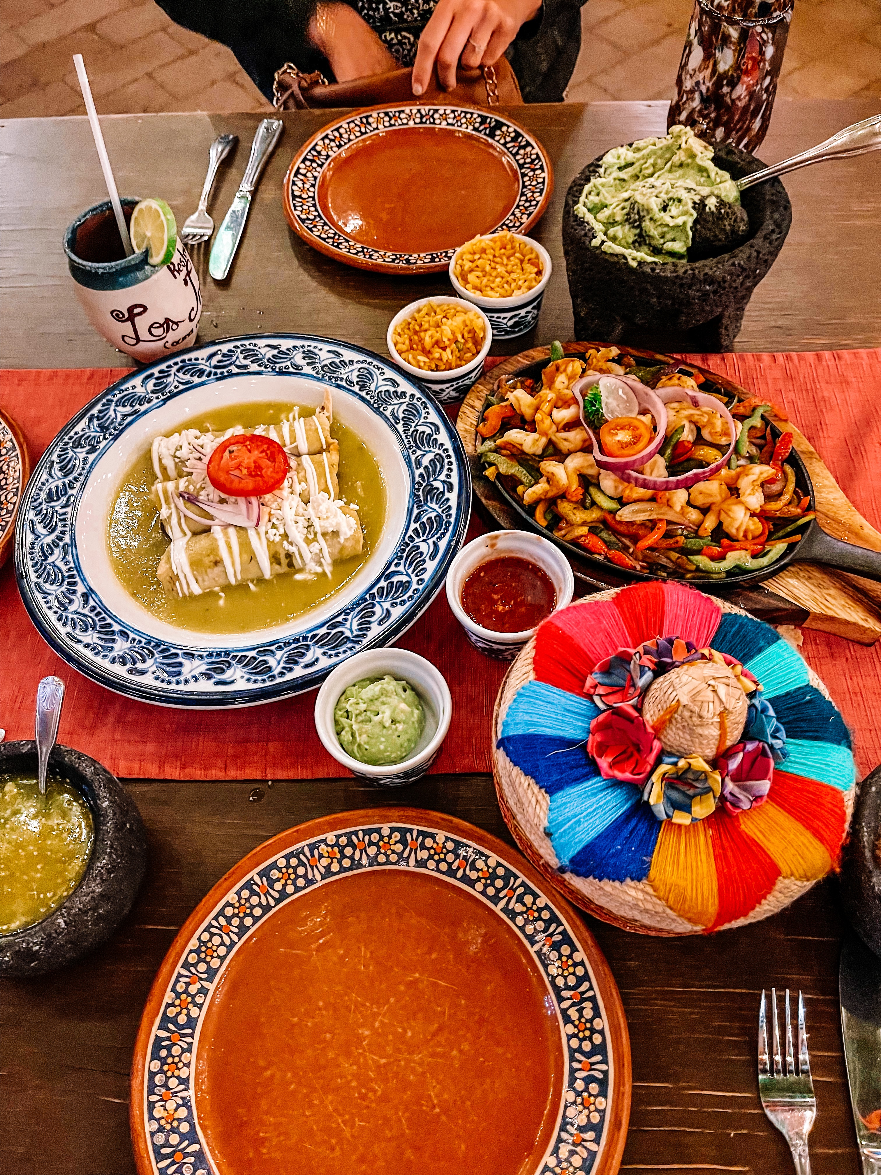 Table of Mexican food; enchiladas, fajitas, guacamole in Cabo